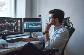 Stock trading day, trader white man, computer, screen, glasses